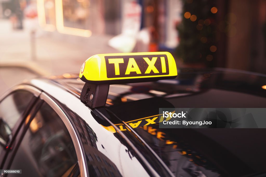 yellow taxi car roof sign at night. taxi car on the street at night